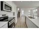 This modern kitchen is equipped with stainless steel appliances, quartz countertops, and a stylish backsplash at 1950 Black Oak Dr, Shelbyville, IN 46176