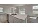 Kitchen island with stainless sink and dishwasher overlooks a bright room with sliding glass doors to the backyard at 1950 Black Oak Dr, Shelbyville, IN 46176