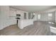 Charming kitchen with stainless appliances, island, and an open view into the living space with hard surface floors at 1950 Black Oak Dr, Shelbyville, IN 46176