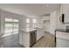 Bright kitchen features an island with a stainless steel dishwasher and gray wood-look floors at 1950 Black Oak Dr, Shelbyville, IN 46176