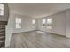 Spacious living room features lots of windows, hard surface flooring, and stairs to the upper level at 1950 Black Oak Dr, Shelbyville, IN 46176