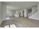 This open-concept living area includes a kitchen and staircase, all illuminated by recessed lighting at 1950 Black Oak Dr, Shelbyville, IN 46176