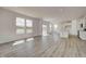 Open-concept living space blending hard surface flooring with a modern kitchen, brightened by natural light at 1950 Black Oak Dr, Shelbyville, IN 46176