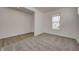Bright living room with a combination of plush carpeting and hard surface flooring and a large window at 1950 Black Oak Dr, Shelbyville, IN 46176