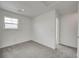 Bedroom with gray carpet, white walls, and a window at 1951 Black Oak Dr, Shelbyville, IN 46176