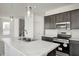 Kitchen island with stainless steel sink and modern lighting fixtures at 1951 Black Oak Dr, Shelbyville, IN 46176