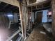 Unfinished basement showing exposed beams, under-floor utility access, and old subfloor at 21 S Warman Ave, Indianapolis, IN 46222