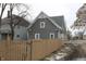 A charming two-story home featuring gray siding, complemented by a well-maintained wooden fence at 21 S Warman Ave, Indianapolis, IN 46222