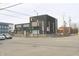 A brick constructed commercial building at a street corner with clear signage visible at 21 S Warman Ave, Indianapolis, IN 46222