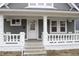 Inviting front porch featuring classic white columns and railing, leading to the home's entrance at 21 S Warman Ave, Indianapolis, IN 46222