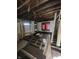An unfinished room with exposed floor joists, partial framing, and natural light coming through the windows at 21 S Warman Ave, Indianapolis, IN 46222
