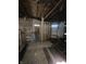 Room under construction with exposed wall studs, open ceiling, and unfinished floors, ready for customization at 21 S Warman Ave, Indianapolis, IN 46222