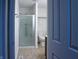Bathroom featuring a glass-enclosed shower, modern toilet, and neutral tile flooring at 2333 Villa Ave, Indianapolis, IN 46203