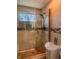 Tiled walk-in shower with a glass door and a small window for natural light at 2333 Villa Ave, Indianapolis, IN 46203