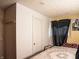 Cozy bedroom featuring a floral comforter, natural light, and simple decor at 2333 Villa Ave, Indianapolis, IN 46203