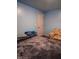 Relaxing bedroom showcasing blue walls, soft lighting, and a comfortable seating area at 2333 Villa Ave, Indianapolis, IN 46203