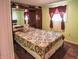 Cozy bedroom features a patterned bedspread and window with valance at 2333 Villa Ave, Indianapolis, IN 46203