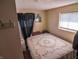 Modest bedroom with natural light, neutral walls, and a comfortable-looking bed at 2333 Villa Ave, Indianapolis, IN 46203