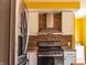 Modern kitchen with stainless steel appliances, mosaic backsplash, and light gray cabinets at 2333 Villa Ave, Indianapolis, IN 46203