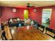 Cozy living room with comfortable seating, a dark wood table and warm, colorful walls at 2333 Villa Ave, Indianapolis, IN 46203