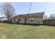 A quaint single-story home with a spacious backyard and a small concrete patio area at 250 Three Notch Ln, Bargersville, IN 46106
