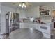 Well-lit eat-in kitchen with modern stainless steel refrigerator and white cabinetry at 250 Three Notch Ln, Bargersville, IN 46106