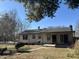 Back exterior of home with sliding glass doors and a small patio at 251 S 12Th Ave, Beech Grove, IN 46107