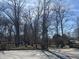 View of wooded backyard with mature trees, a playset, and a quaint wooden fence at 251 S 12Th Ave, Beech Grove, IN 46107