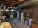 Utility area with exposed ductwork and utilities like water heater, sump pump, and exposed duct work at 251 S 12Th Ave, Beech Grove, IN 46107