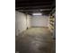 Unfinished basement offering space for storage or future renovations with shelves and concrete floors at 251 S 12Th Ave, Beech Grove, IN 46107