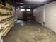 Unfinished basement space with concrete floor and block walls, shelving, and natural light at 251 S 12Th Ave, Beech Grove, IN 46107