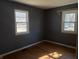 Bedroom with hardwood floors, two large windows, and neutral paint at 251 S 12Th Ave, Beech Grove, IN 46107