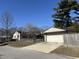 View of home with a detached garage, a driveway, and a fenced in yard at 251 S 12Th Ave, Beech Grove, IN 46107