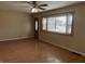 View of living room with wood laminate floors, a ceiling fan and a front door at 251 S 12Th Ave, Beech Grove, IN 46107