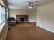 Spacious living room featuring a brick fireplace and hardwood floors at 251 S 12Th Ave, Beech Grove, IN 46107