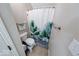 Functional bathroom with a toilet and shower featuring a decorative leaf-patterned curtain at 2552 Spring Hill Ct, Indianapolis, IN 46268