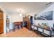 Compact dining area featuring wood floors, a modern light fixture, and a large accent wall art at 2552 Spring Hill Ct, Indianapolis, IN 46268