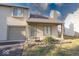 Charming condo with attached garage and front yard is surrounded by green grass and mature trees at 2552 Spring Hill Ct, Indianapolis, IN 46268