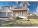 Charming condo with attached garage and front yard is surrounded by green grass and mature trees at 2552 Spring Hill Ct, Indianapolis, IN 46268
