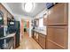 A well-lit kitchen features wood-look floors, brown cabinets, black appliances and a sink beneath the window at 2552 Spring Hill Ct, Indianapolis, IN 46268