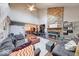 Bright living room boasts high ceilings, a stone fireplace, hardwood floors, and plenty of natural light at 2552 Spring Hill Ct, Indianapolis, IN 46268