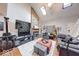 Bright living room boasts high ceilings, a stone fireplace, hardwood floors, and plenty of natural light at 2552 Spring Hill Ct, Indianapolis, IN 46268