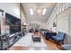 Bright living room boasts high ceilings, a stone fireplace, hardwood floors, and plenty of natural light at 2552 Spring Hill Ct, Indianapolis, IN 46268