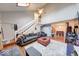 Bright living room boasts high ceilings, a stone fireplace, hardwood floors, and plenty of natural light at 2552 Spring Hill Ct, Indianapolis, IN 46268