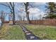 Large backyard featuring a stone paver walkway and privacy fence, perfect for outdoor activities and relaxation at 2626 E 18Th St, Indianapolis, IN 46218