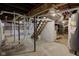 Spacious unfinished basement with exposed plumbing, shelving, and natural light at 2626 E 18Th St, Indianapolis, IN 46218