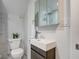 A modern bathroom features a stylish vanity, medicine cabinet and marble tiling at 2626 E 18Th St, Indianapolis, IN 46218