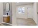 Stylish bathroom featuring a modern vanity, a sleek mirror, and wood-look floors at 2626 E 18Th St, Indianapolis, IN 46218