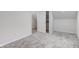Bright bedroom with a door to the hallway and closet storage at 2626 E 18Th St, Indianapolis, IN 46218