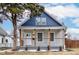 Charming renovated home featuring a covered porch with updated railings and a fresh blue and gray color scheme at 2626 E 18Th St, Indianapolis, IN 46218
